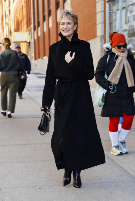 Robin Wright – In a black trench coat and knee long boots in New York