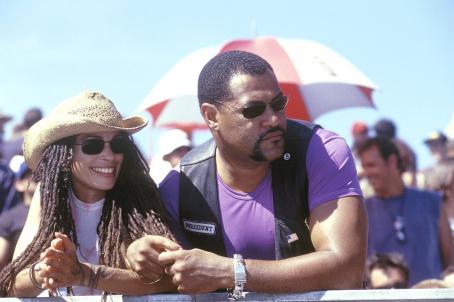 Queenie (Lisa Bonet) and Smoke (Laurence Fishburne) watch a race from ...