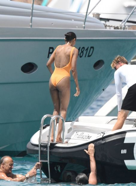 Zoe Saldana – Is Seen in a orange swimsuit in Sardinia