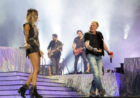 INDIO, CALIFORNIA - APRIL 30: Axl Rose of Guns N' Roses performs onstage with Carrie Underwood during Day 2 of the 2022 Stagecoach Festival at the Empire Polo Field