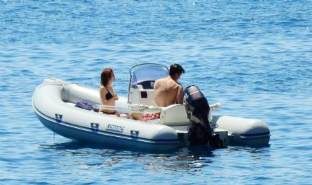 Zoey Deutch in Black Bikini on holiday in Ischia