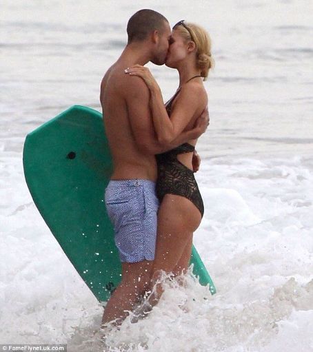 Paris Hilton shares passionate kiss on the beach with mystery man