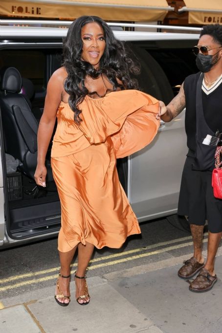 Kenya Moore – Wearing a bright orange dress at Bauer Media offices in London