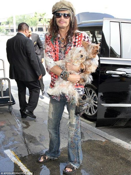 Steven Tyler shows sweet emotion as he beams while carrying precious pups to take flight out of LAX